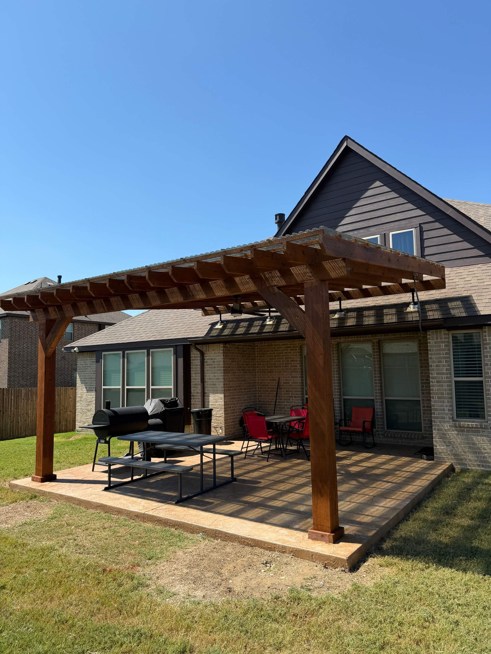 Custom pergola with polycarbonate roofing and ceiling fan in Plano Texas