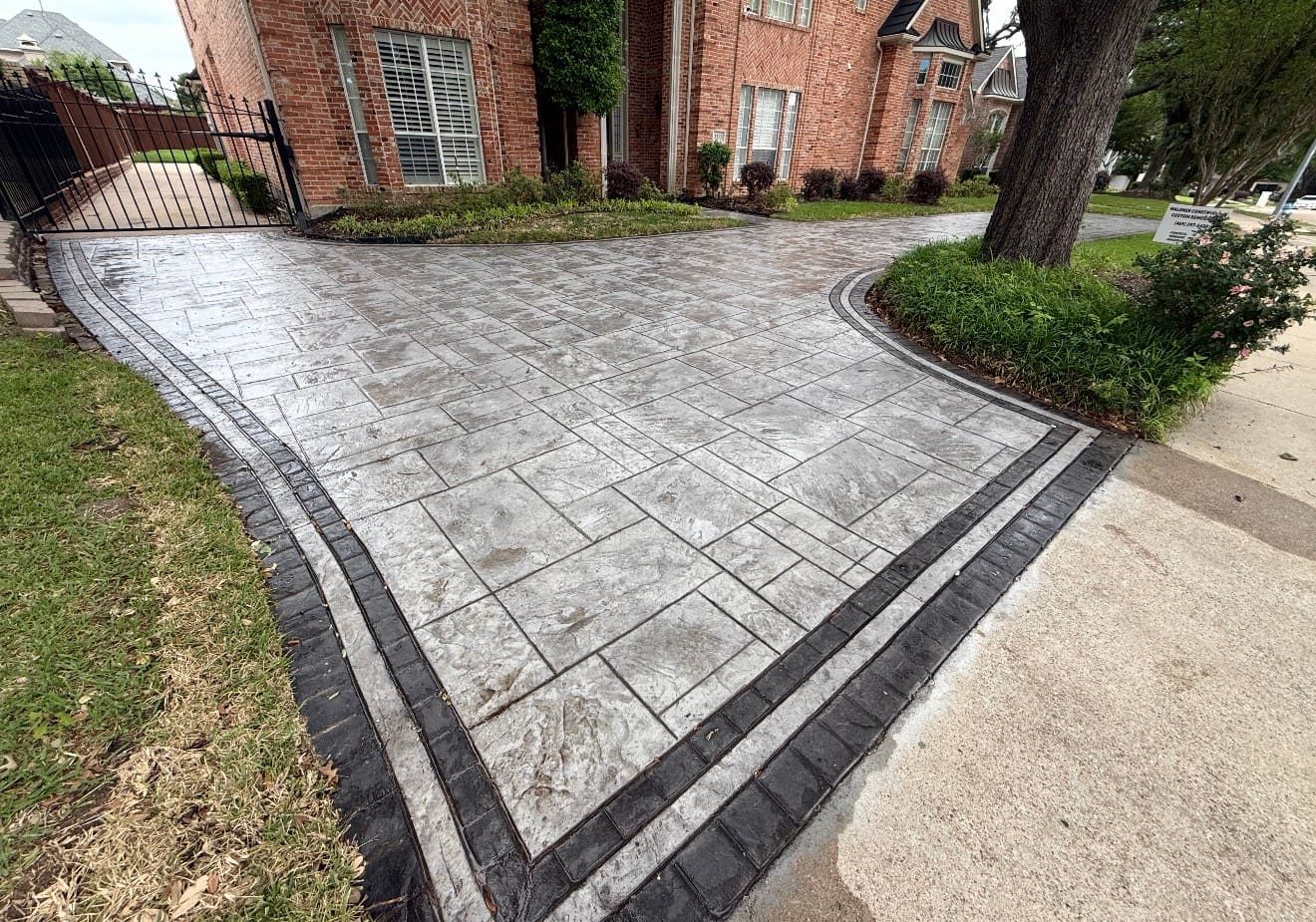 Stamped concrete driveway with decorative border in Dallas, Texas