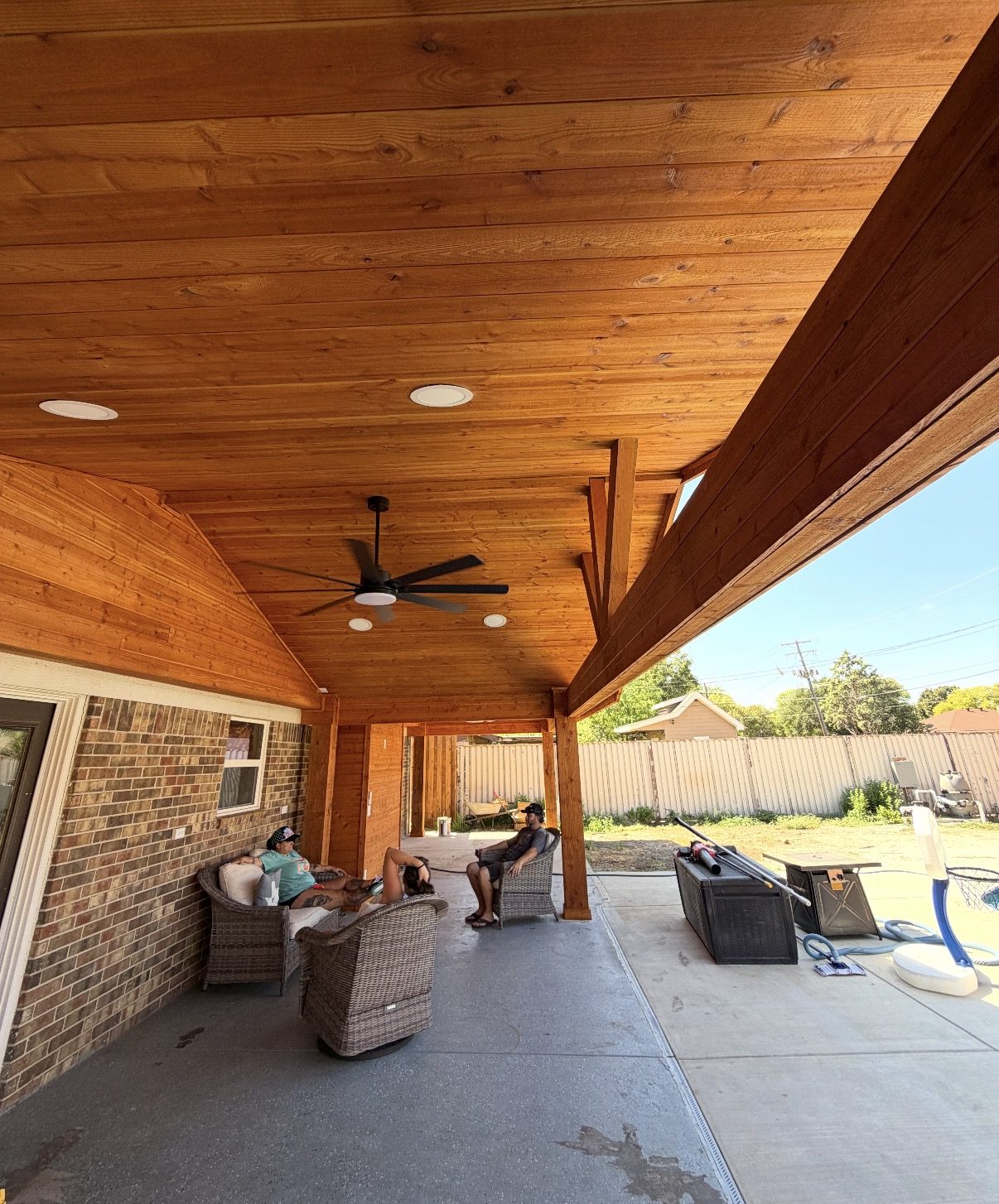 Tongue-and-groove cedar ceiling with fan and recessed lights under a gable home extension in Watauga, Texas